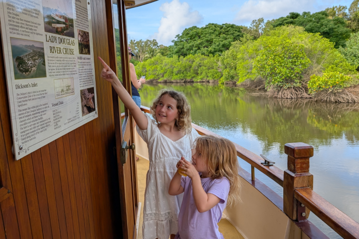 a young boy standing in front of water