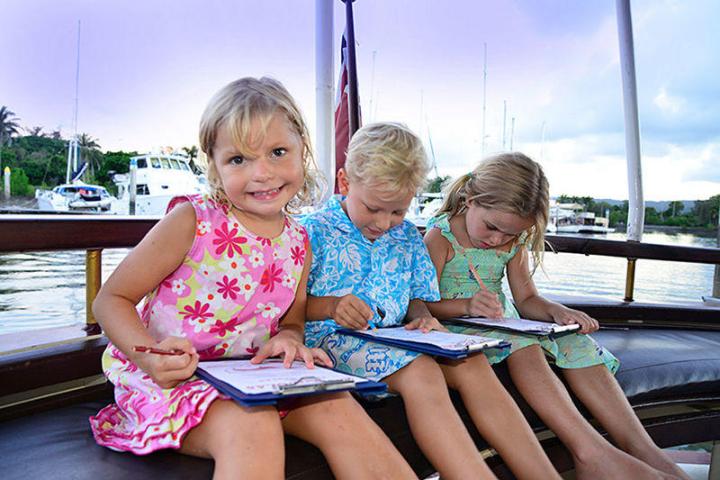 a little girl sitting on a bench
