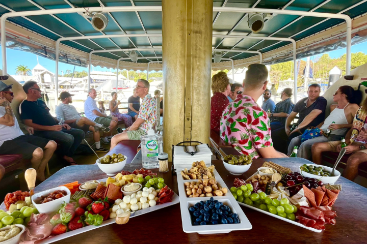 a group of people sitting at a table with food