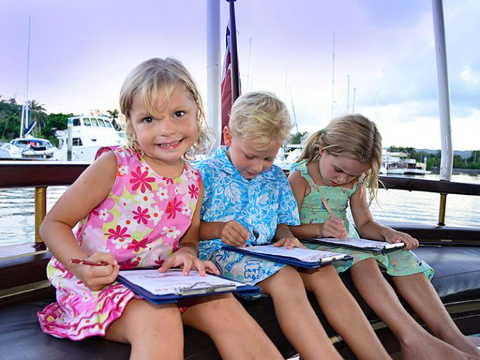 a little girl sitting on a bench