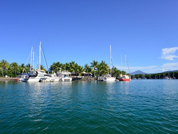 a boat is docked next to a body of water
