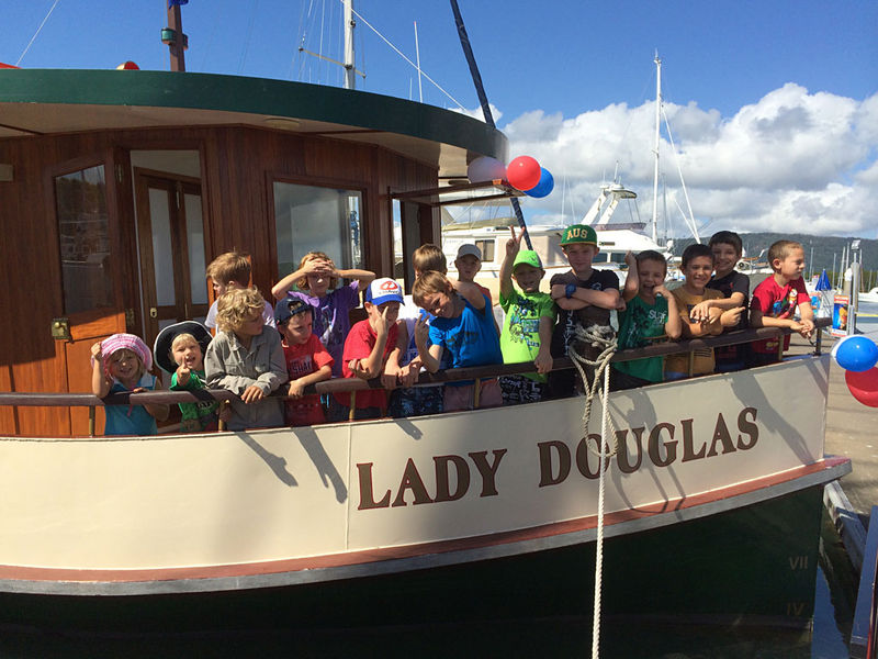a group of people riding on the back of a boat