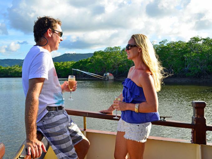 a man and a woman standing next to a body of water