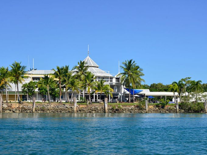 a group of lawn chairs sitting on top of a body of water