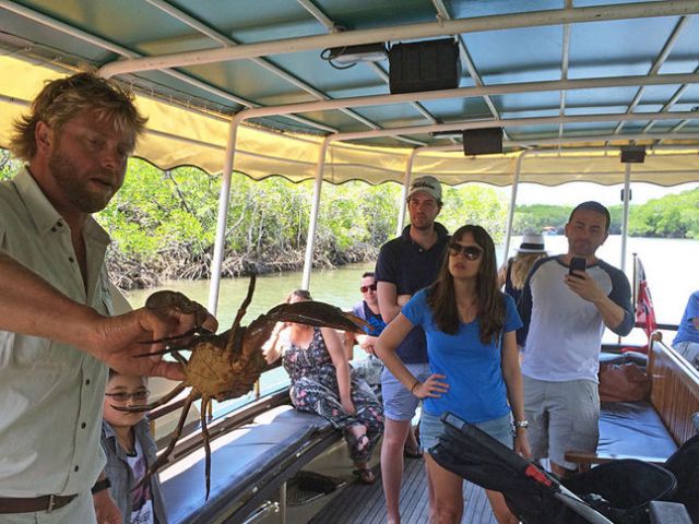 a group of people riding on the back of a boat