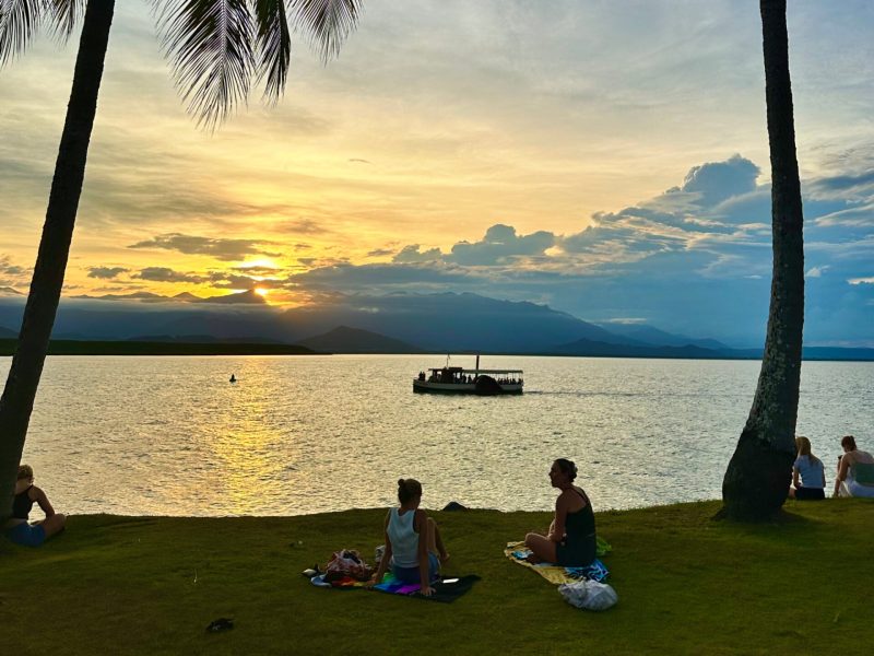 a group of people on a beach near a body of water